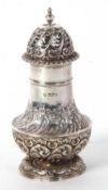 A late Victorian silver caster of baluster form, having a pull-off pierced and gadrooned decorated