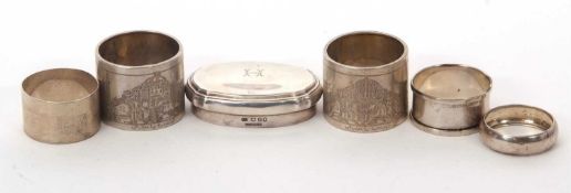 Mixed Lot: A pair of large white metal serviette rings, engraved to one side with temples, stamped
