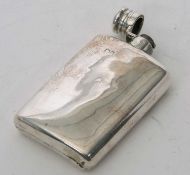 An early 20th Century silver spirit flask of slight curved rectangular form having a bayonet fitting