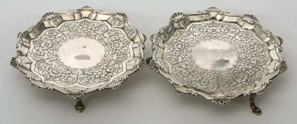 Two Georgian silver waiters, both having a scroll and shell decorated rim and a floral and leaf