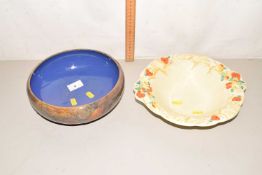 A Royal Doulton stone ware bowl decorated with Autumn leaves together with a Clarice Cliff Celtic