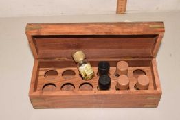 A hardwood box containing essential oils
