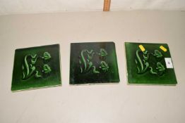 A set of three Victorian green glazed tiles