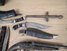 Group of various Far Eastern daggers, Kukri's and two further flint lock pistols, a lot of pieces