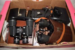 A box of various binoculars
