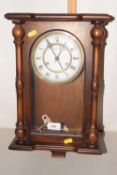 A wooden wall clock