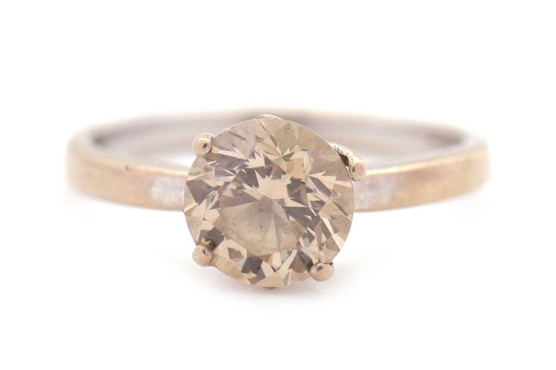 An 18ct champagne diamond solitaire ring, the round brilliant cut diamond, estimated approx. 1. - Image 1 of 9