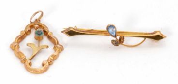A blue stone bar brooch, stamped 9ct, 40mm long, 0.9g, and a blue stone pendant indistinctly stamped