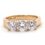 A 9ct CZ ring, the three round CZ's with tapering shoulders and plain band stamped 375 with