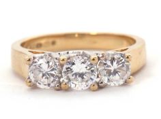 A 9ct CZ ring, the three round CZ's with tapering shoulders and plain band stamped 375 with
