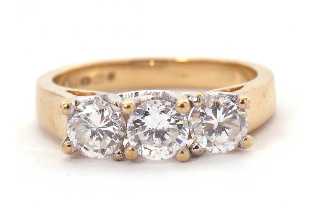 A 9ct CZ ring, the three round CZ's with tapering shoulders and plain band stamped 375 with - Image 1 of 8