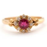 An 18ct Edwardian ruby and diamond ring, the central round ruby surrounded by single cut diamonds