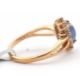 A 9ct sapphire and white zircon ring, the central oval sapphire cabochone, surrounded by small round - Image 2 of 6