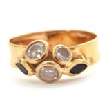 A custom made gemset ring, set with two blue-black marquise sapphires and three white stones, all in
