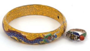 A Chinese cloisonne bangle and a ring: the yellow cloissone bangle decorated with two dragons,