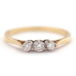 An 18ct three stone diamond ring, the three round brilliant cut diamonds, total estimated approx.