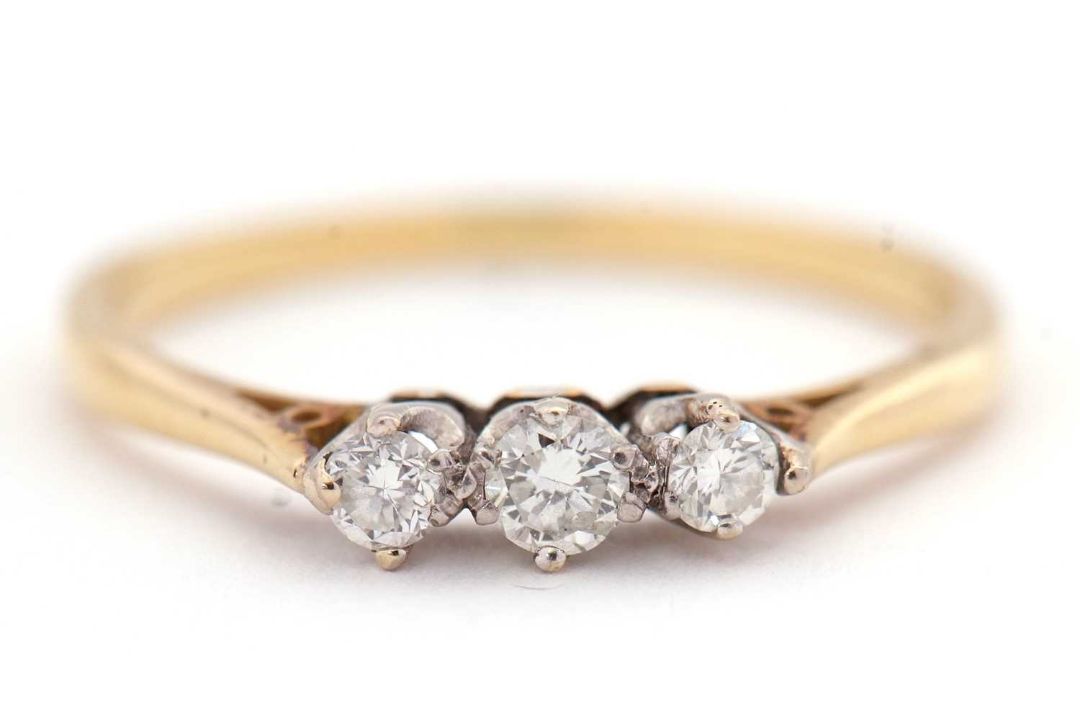 An 18ct three stone diamond ring, the three round brilliant cut diamonds, total estimated approx. - Image 1 of 7