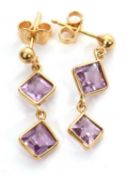 A pair of 18ct amethyst earrings, the square step cut amethysts with posts stamped 750, 23mm long,