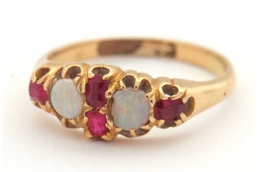 An opal and ruby ring, wtih two round opal cabochons and small round faceted rubies, with tapered - Image 2 of 6