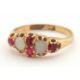 An opal and ruby ring, wtih two round opal cabochons and small round faceted rubies, with tapered - Image 2 of 6