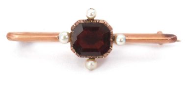 A garnet and cultured pearl brooch, the octagonal collet mounted garnet, with a pearl to each of the