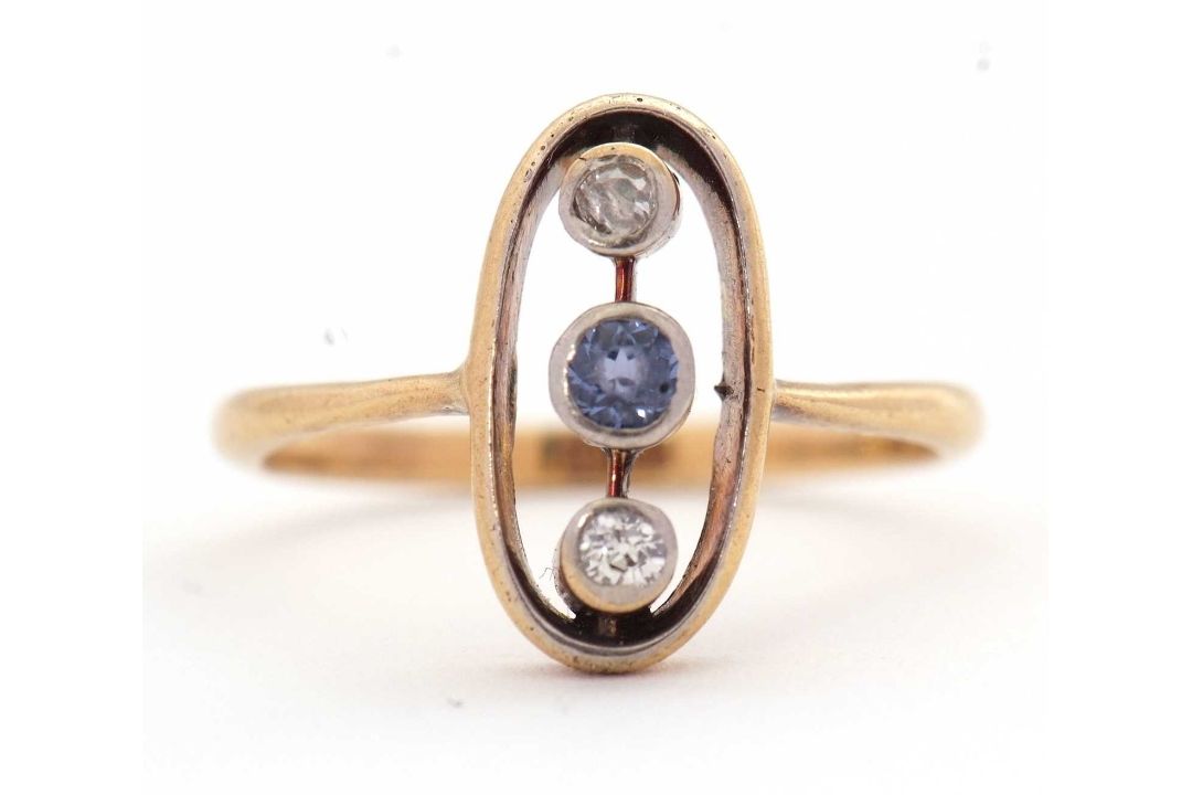 A sapphire and diamond ring, the oval frame with two collet mounted old mine cut diamonds and a - Image 1 of 7