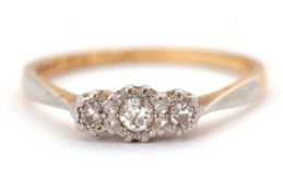 A diamond ring, set with three graduated illusion set diamonds, with plain band stamped '18ct Plat',