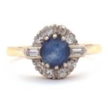 A sapphire and diamond ring, the central round sapphire surrounded by single cut diamonds and a