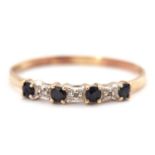 A sapphire and diamond ring, the alternating round sapphires interspaced with diamond hightlights,