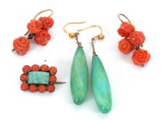 A pair of carved coral earrings, each set with four carved coral roses, with unmarked yellow metal