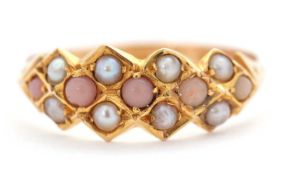 A late Victorian 15ct seed pearl and coral ring, with four round coral cabochons and seed pearls