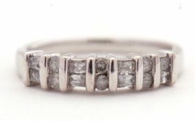 A 14K diamond ring, alternatively set with two baguette and two round brilliant cut diamonds,