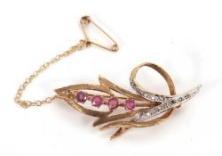 A 9ct gemset brooch, the open leaf shape brooch set with four round pink sapphires and white