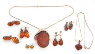 A quantity of amber and silver jewellery, to include a large oval amber pendant, 5cm long, a heart