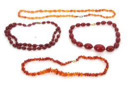 A quantity of bakelite 'cherry amber' and amber necklaces: to include a graduated oval bead