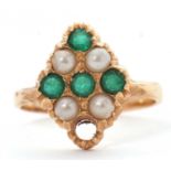 A gemset ring, set with green stones and faux pearls, all set in unmarked yellow metal (tests as