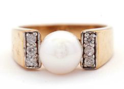 A 9ct pearl and diamond ring, the cultured pearl cup mounted with three small round brilliant cut