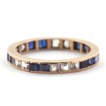 A blue and white stone eternity ring, the full hoop ring with channel set with blue and white