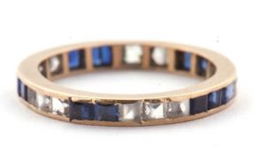 A blue and white stone eternity ring, the full hoop ring with channel set with blue and white