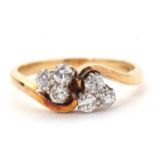 A diamond ring, the crossover style ring set with two trefoils of small round mixed cut diamonds,