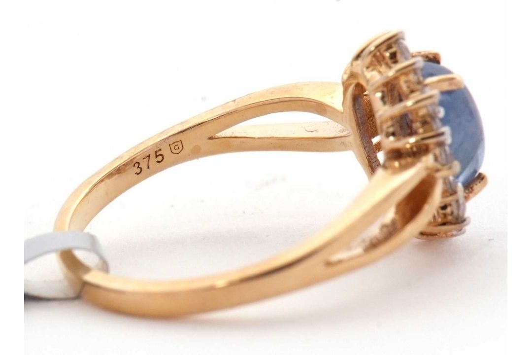 A 9ct sapphire and white zircon ring, the central oval sapphire cabochone, surrounded by small round - Image 3 of 6