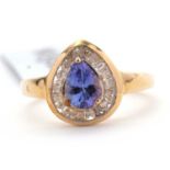 A 9ct tanzanite and white zircon ring, the pear shape tanzanite surrounded by baguette cut white