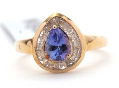 A 9ct tanzanite and white zircon ring, the pear shape tanzanite surrounded by baguette cut white