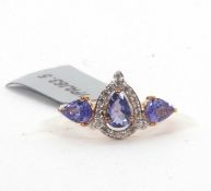 A 9ct tanzanite and white zircon ring, the central pear shape tanzanite surrounded white small white