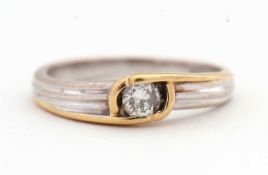 An 18ct bi-colour gold and diamond ring, the central round brilliant cut diamond, estimated