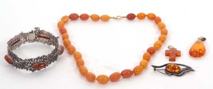 A quantity of amber jewellery: to include a continental silver and amber cabochon bracelet, with