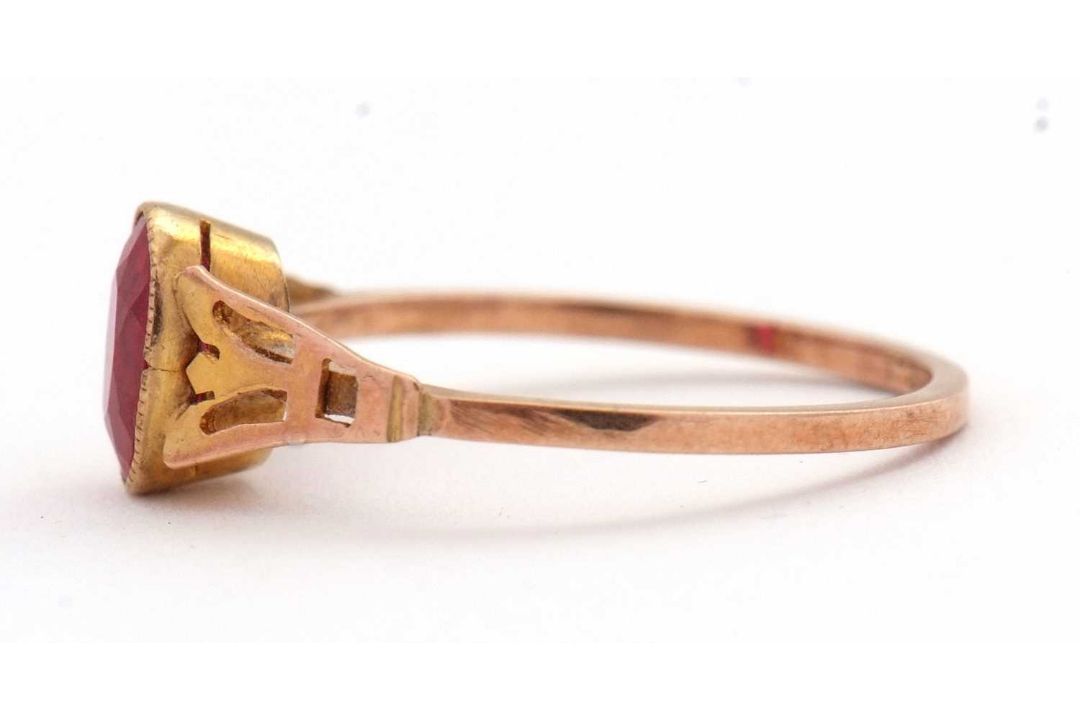 A synthetic ruby ring, the oval synthetic ruby with tapered shoulders and plain band stamped 9ct, - Image 2 of 8