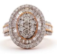 A 9ct diamond ring, with a central oval pave diamond panel, surrounded by tapered diamond baguettes,