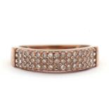 A diamond ring, set with three rows of small round brilliant cut diamonds, total estimated approx.