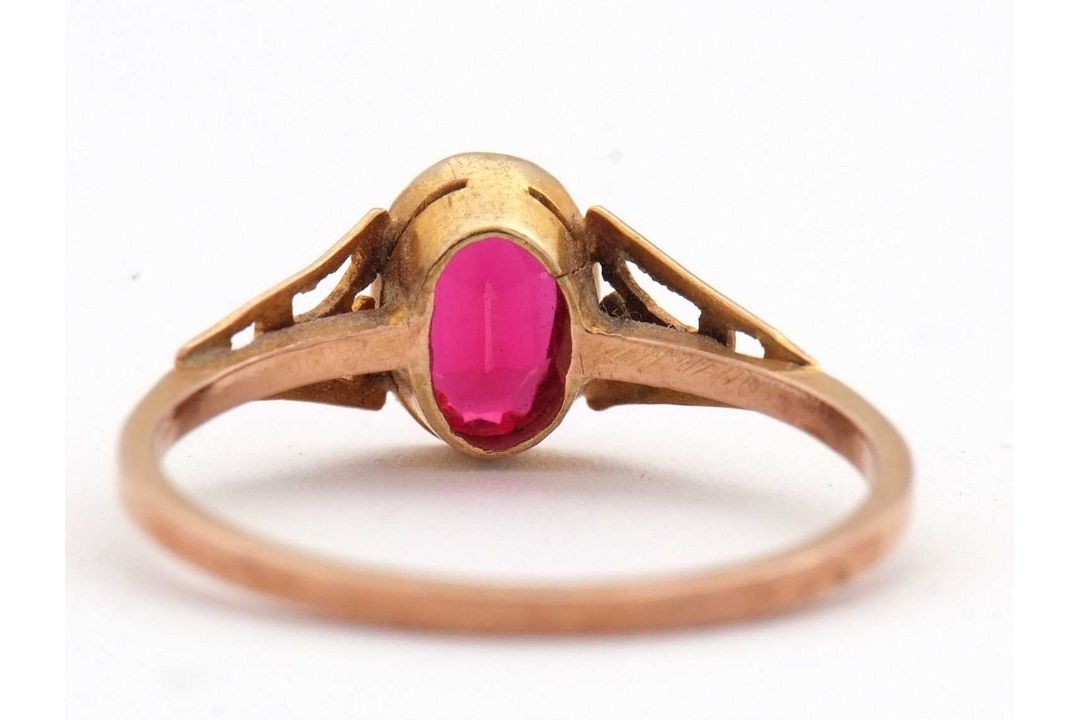 A synthetic ruby ring, the oval synthetic ruby with tapered shoulders and plain band stamped 9ct, - Image 6 of 8